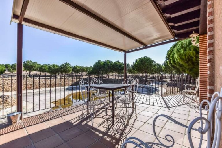 Porch with table and chairs overlooking the Pinar pond